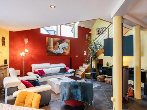 ガンガンにあるTi harmonielの赤い壁と白い家具が備わるリビングルーム