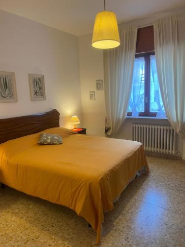 a bedroom with a large bed with a yellow blanket at B&b Cristina - Appartamento Monte Coccia in Campo di Giove