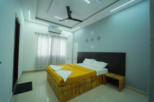 a bedroom with a bed and a ceiling at Nandan Elite 3bhk in Mysore