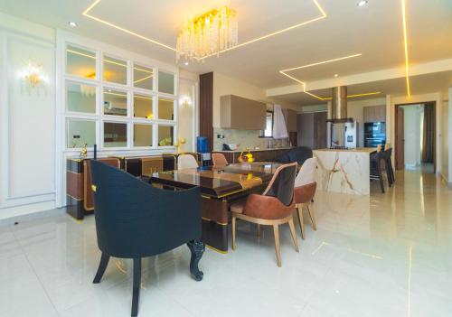 a kitchen and dining room with a table and chairs at Mira Heights Suites & Conferencing Mombasa in Mombasa