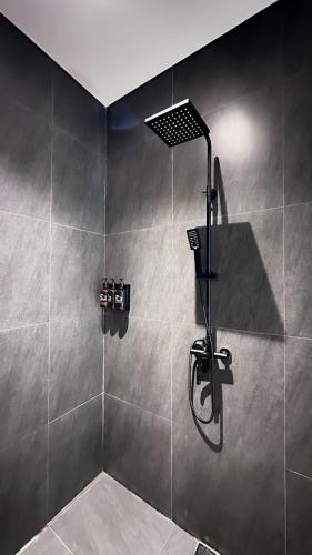 a shower with a shower head in a bathroom at 3BR Nava villa Ubud in Ubud