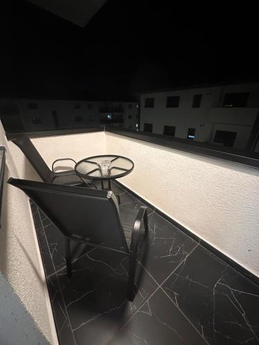 a chair sitting on the roof of a building at Two modern apartments in Sibiu