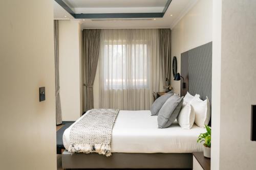 Postel nebo postele na pokoji v ubytování Fontis Residences Hotel