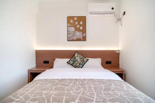 Ένα ή περισσότερα κρεβάτια σε δωμάτιο στο Guiyng Aixin International Apartment Future Ark Store