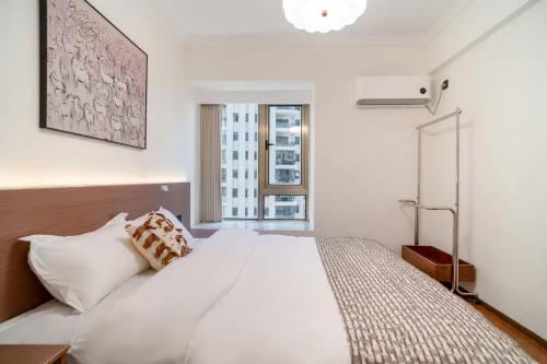 Ένα ή περισσότερα κρεβάτια σε δωμάτιο στο Guiyng Aixin International Apartment Future Ark Store