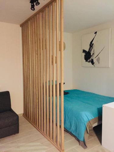 a bedroom with a bed and a window with a helicopter at Marco Polo 3 pers pool in Mandelieu-La Napoule