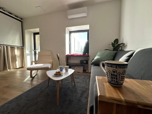 a living room with a couch and a table at Maison avec jardin, wifi, parking, vidéo projecteur in Tulle