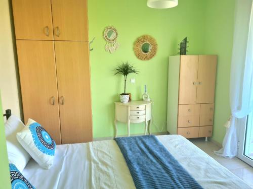 a bedroom with a bed and a table with a plant at IRIA Beach in Iria
