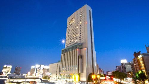 a tall building in a city at night at ANA Crowne Plaza Hotel Grand Court Nagoya by IHG in Nagoya