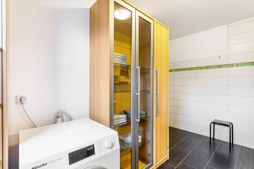 a kitchen with a washer and dryer in a room at Ferienwohnung am Schmenkenberg in Marsberg