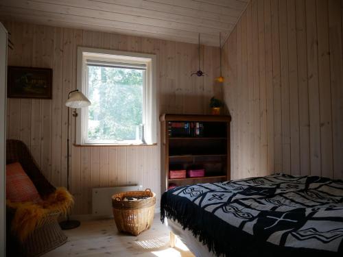 a bedroom with a bed and a window at Summerhouse in Ulvshale, Møn in Stege
