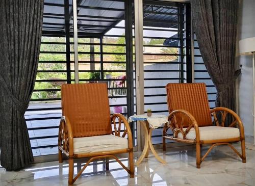 two chairs and a table on a porch at Grace Homestay Taiping in Taiping