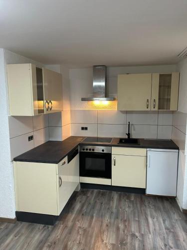 a kitchen with white cabinets and a black counter top at Walldürn Zentrum 1 in Walldürn