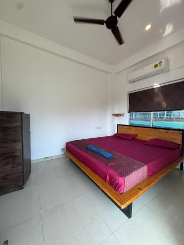 a large bed in a room with a ceiling at Happy Homes by Yoga & Smiles, Upper Tapovan in Rishīkesh