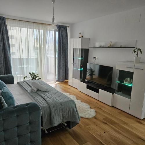 a living room with a couch and a large television at FourSeasons Residence in Braşov