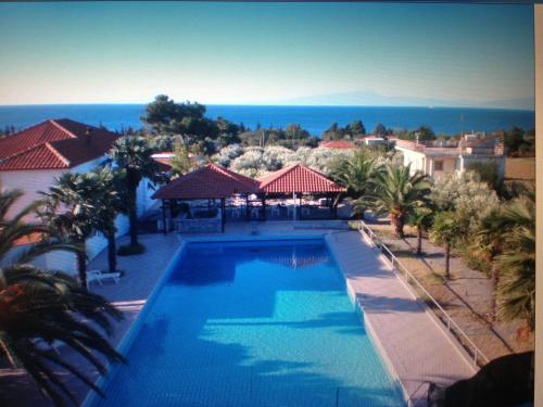 a view of a swimming pool at a resort at Oasis Room's in Néa Michanióna