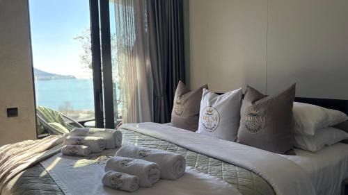 two beds in a hotel room with towels on them at KRUNA 406 Apartment in Becici