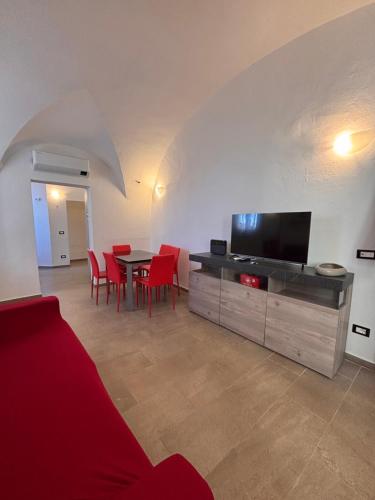 a living room with a table and red chairs at Chez Gabry in Sanremo