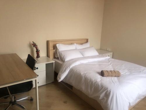 a bedroom with a bed with a desk and a computer at Miassine Boutique Hotel in Gyumri