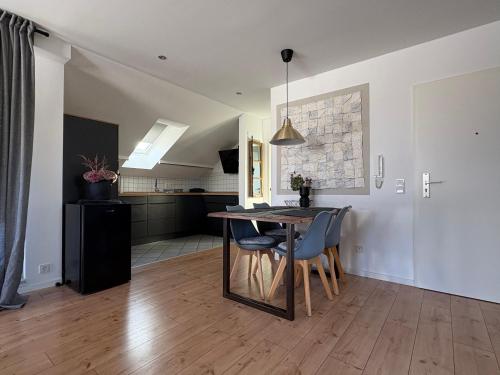 a kitchen and dining room with a table and chairs at SkyLoft Rheinland in Bornheim
