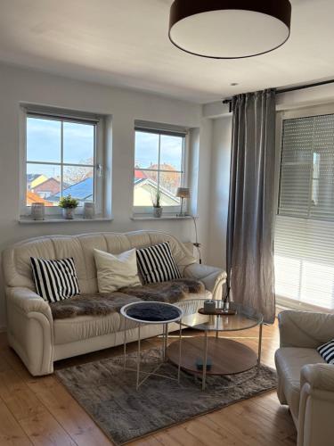 a living room with a couch and a table at SkyLoft Rheinland in Bornheim