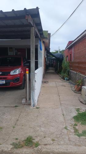 a car parked outside of a building with a garage at Casa cerca de la playa in La Paloma