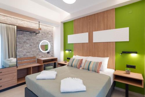 a bedroom with a large bed with a green wall at Chania Experience Residence in Chania