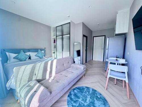 a living room with a couch and a bed at Title Ledgendary 7th Floor in Bang Tao Beach