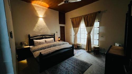 a bedroom with a bed and a window at Three-Bedroom Holiday Home in Abbottabad