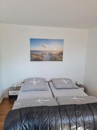 a bedroom with a bed with two pillows on it at Baltic Apartment in Lambrechtshagen