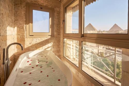 a hospital bed in a room with two windows at 7 Gates Boutique Hotel Pyramids in Cairo