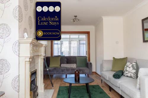 a living room with a couch and a table at Gunn House in Grangemouth