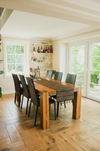a dining room with a wooden table and chairs at TheLodge in Welzheim