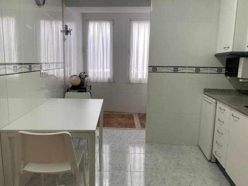a kitchen with a white counter and some windows at Singular piso junto al puerto - Arostegi Etxea in Bermeo