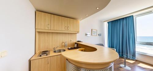 a kitchen with a wooden sink and a window at Effect Grand Victoria Hotel - Ultra All Inclusive in Sunny Beach