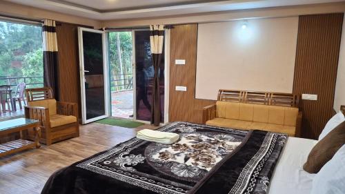 a bedroom with a bed and a living room at Greenary homestay in Ooty