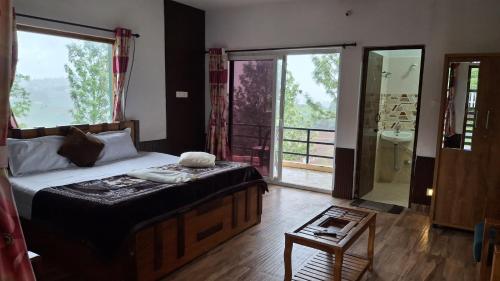 a bedroom with a bed and a bathroom with a shower at Greenary homestay in Ooty