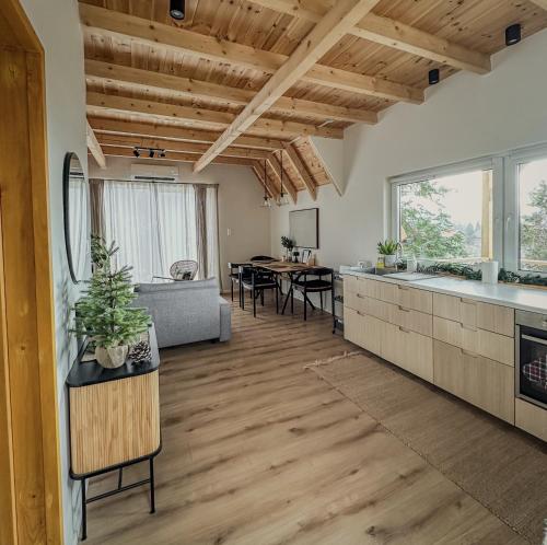 a kitchen and living room with a couch and a table at Zebi vendégház in Zebegény