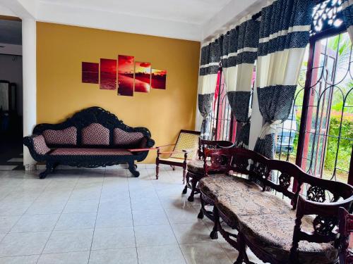a living room with a couch and chairs in it at Harshi Guest House in Matara