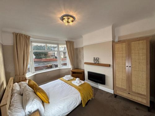 a bedroom with a large bed and a window at Entire House, Parking, Facilities, sleeps up to 6, suitable for contractors, families or NHS in Liverpool
