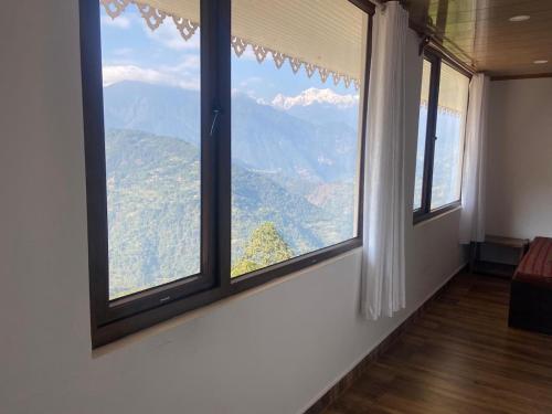 a room with a window with a view of a mountain at DreamVilla Retreat Apartment Pelling in Pelling