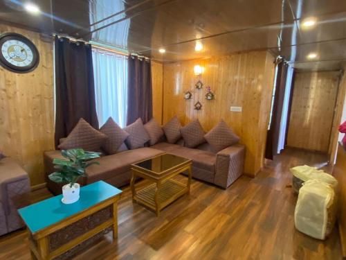 a living room with a couch and a table at DreamVilla Retreat Apartment Pelling in Pelling