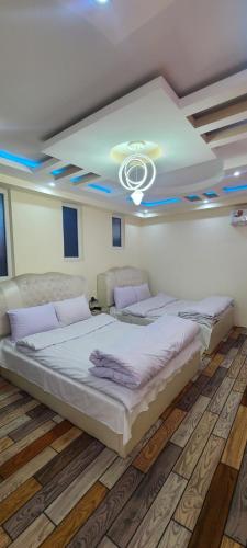 a large bed in a room with a ceiling at Xiang ge li la Hotel 喀布尔香格里拉酒店 in Kabul