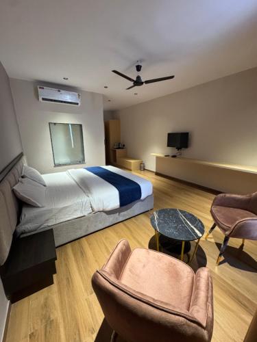 a bedroom with a bed and a table and chairs at Hotel The Luxury Inn in Nāgaur