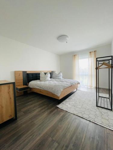 a white bedroom with a bed and a window at Exklusive Haushälfte zentrumsnah in Magdeburg