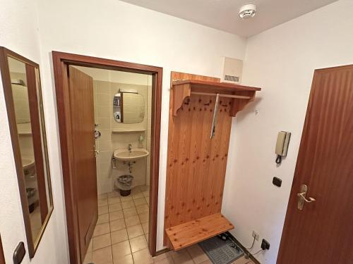 een badkamer met een toilet en een houten deur bij Gschwendtnerhof App17 Blum in Aschau im Chiemgau