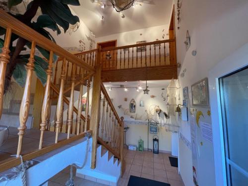 a staircase in a building with a wooden stair case at Fewo Anders Nr1 in Neue Tiefe Fehmarn