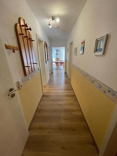 a hallway leading to a room with a door and a hallwayngth at Fewo Anders Nr1 in Neue Tiefe Fehmarn