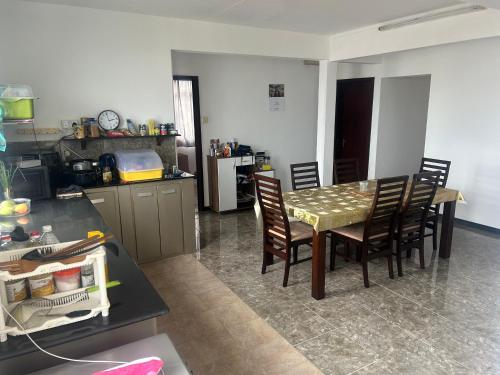 a kitchen with a table and chairs in a room at Coconut House in Albion