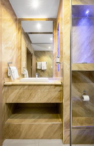 a bathroom with a sink and a mirror at CheckInn Garki, Abuja in Abuja